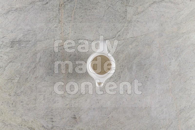 Top View Shot Of A Ceramic Milk Jug On Grey Marble Flooring