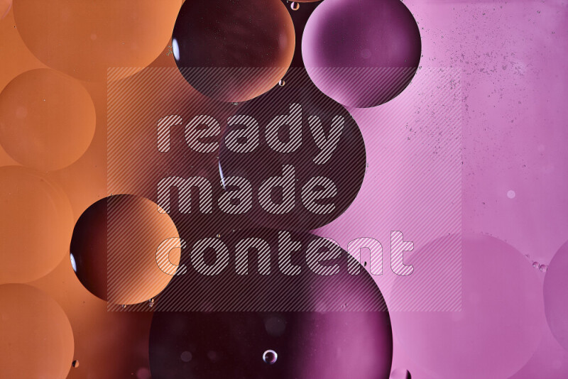 Close-ups of abstract oil bubbles on water surface in shades of orange and pink