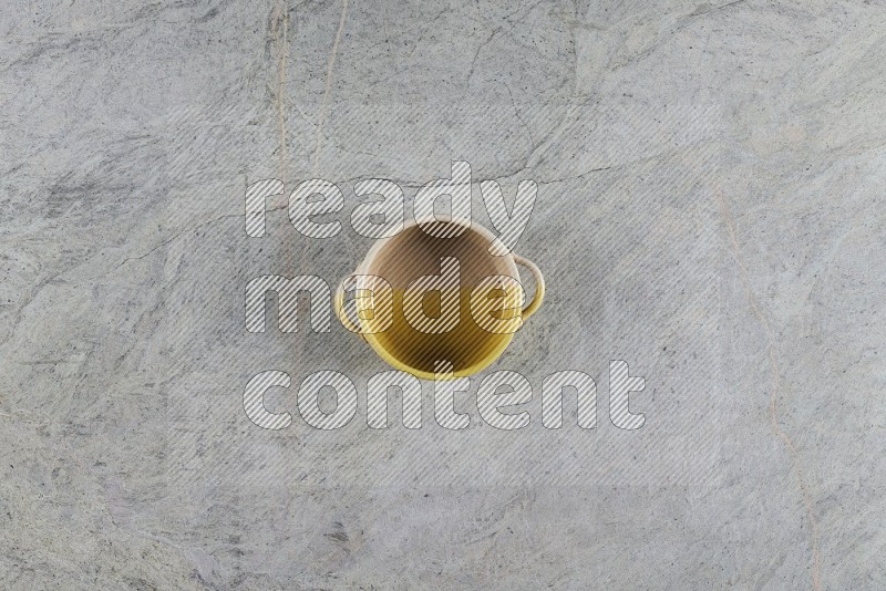 Top View Shot Of A Multicolored Pottery Bowl On Grey Marble Flooring