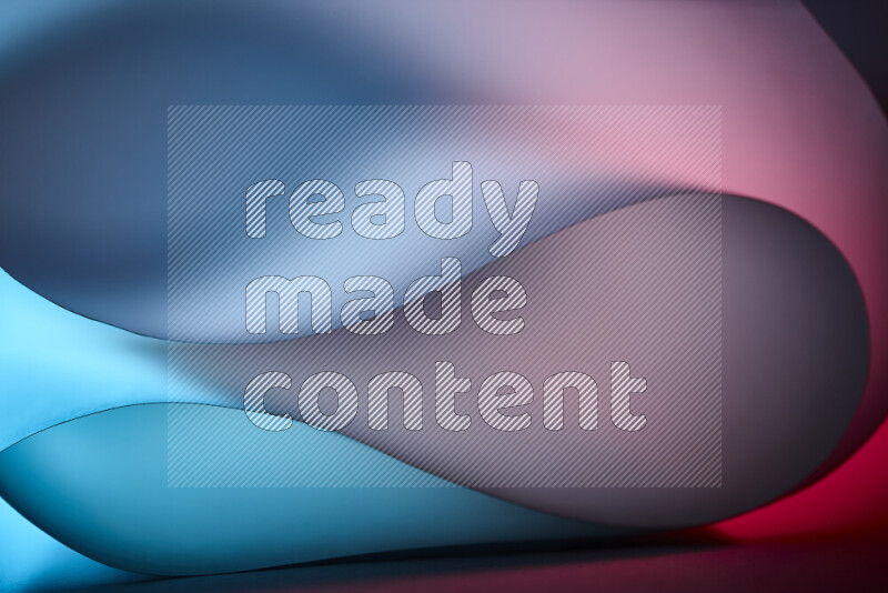 An abstract art piece displaying smooth curves in blue and red gradients created by colored light