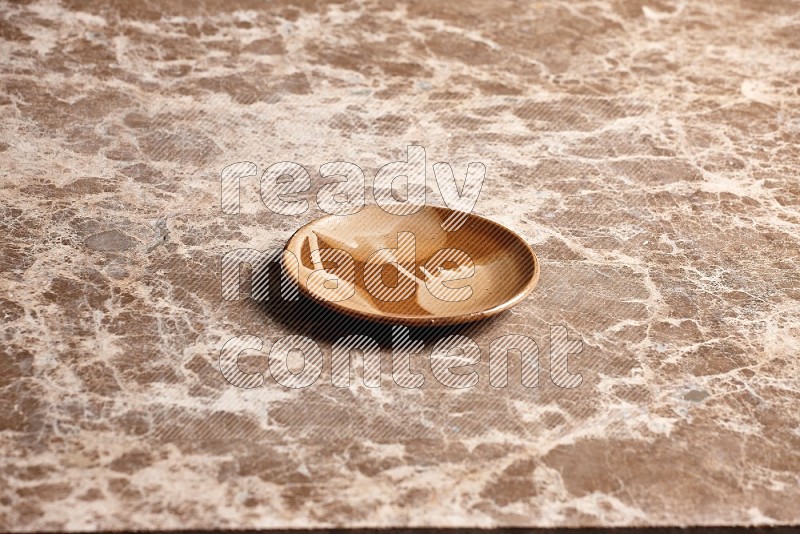 Multicolored Pottery Plate on Beige Marble Flooring, 45 degrees