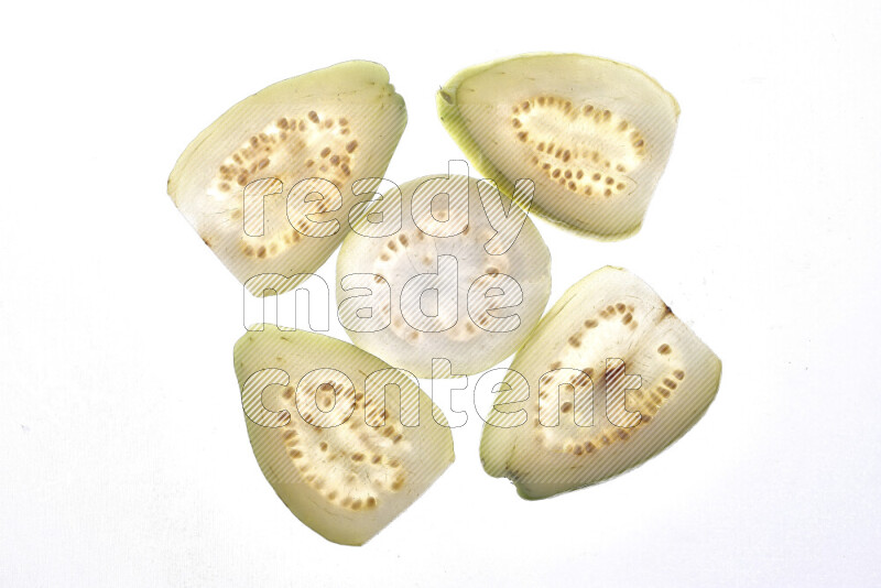 Guava slices on illuminated white background