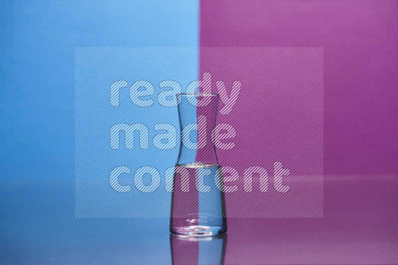 The image features a clear glassware filled with water, set against blue and purple background