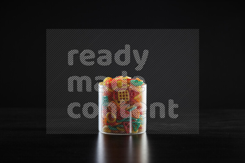 Snacks in a glass jar on black background
