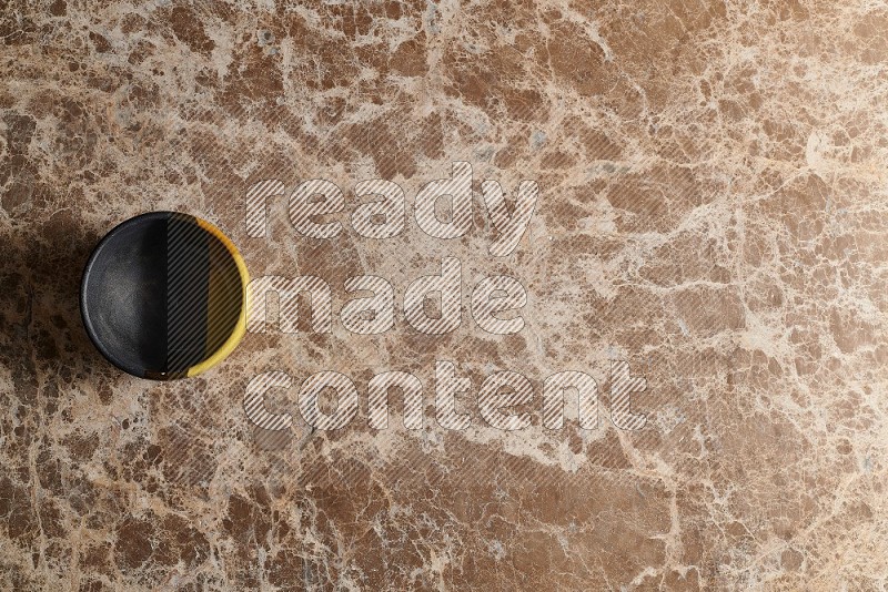 Top View Shot Of A Multicolored Pottery bowl On beige Marble Flooring