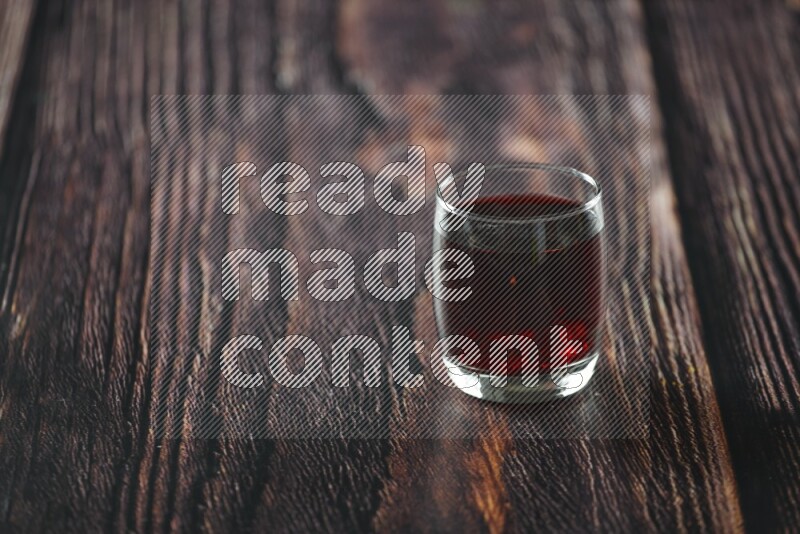 Cold drinks in a glass cup such as water, tamarind, qamar eldin, sobia, milk and hibiscus on wooden background