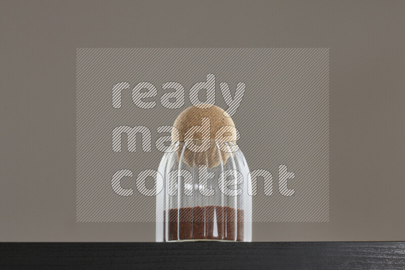 Garden cress in a glass jar on black background