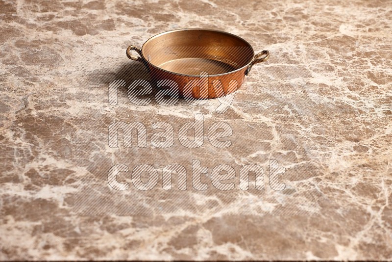 Small Copper Pan on Beige Marble Flooring, 45 degrees