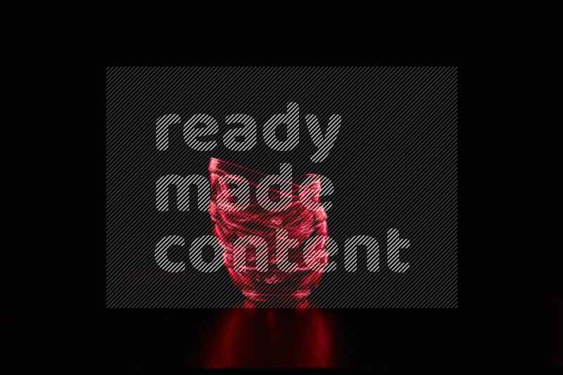 Glassware with rim light in red against black background