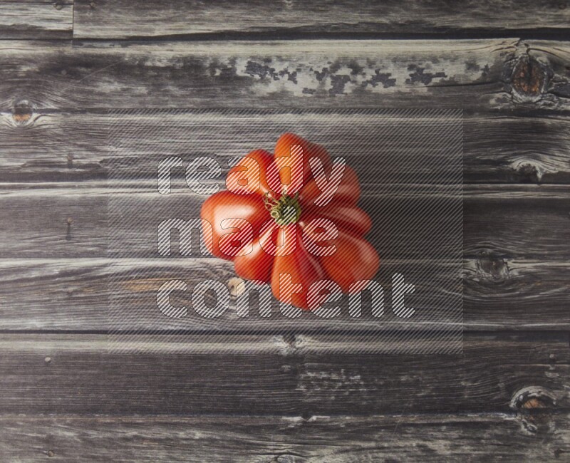 Single Tipview Heirloom Tomato on grey wooden background