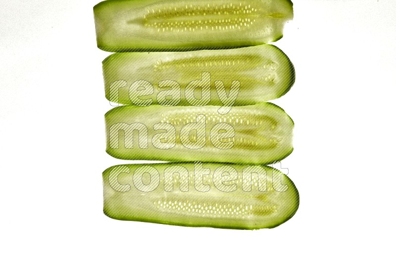 Zucchini slices on illuminated white background