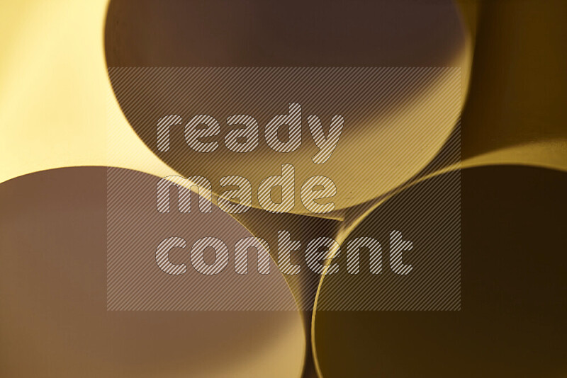 The image shows an abstract paper art with circular shapes in varying shades of gold