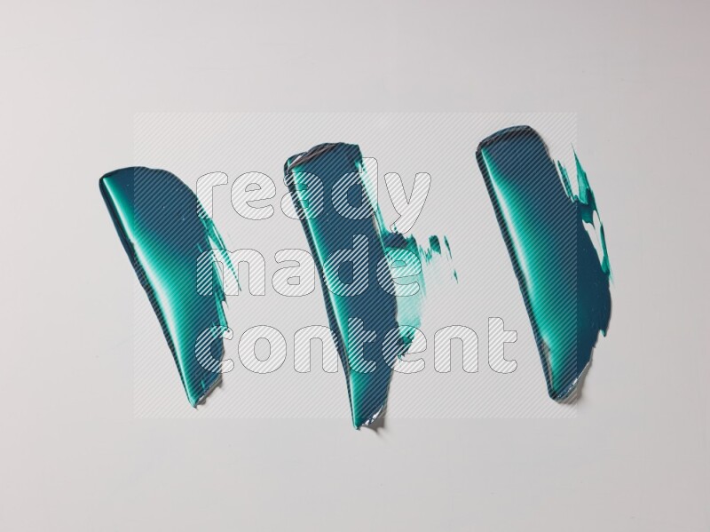 Turquoise painting knife strokes on white background