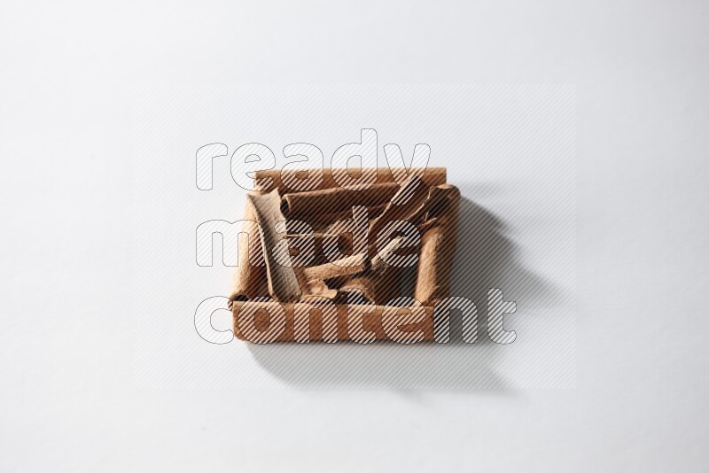 A single square of cinnamon sticks full of cinnamon on white flooring