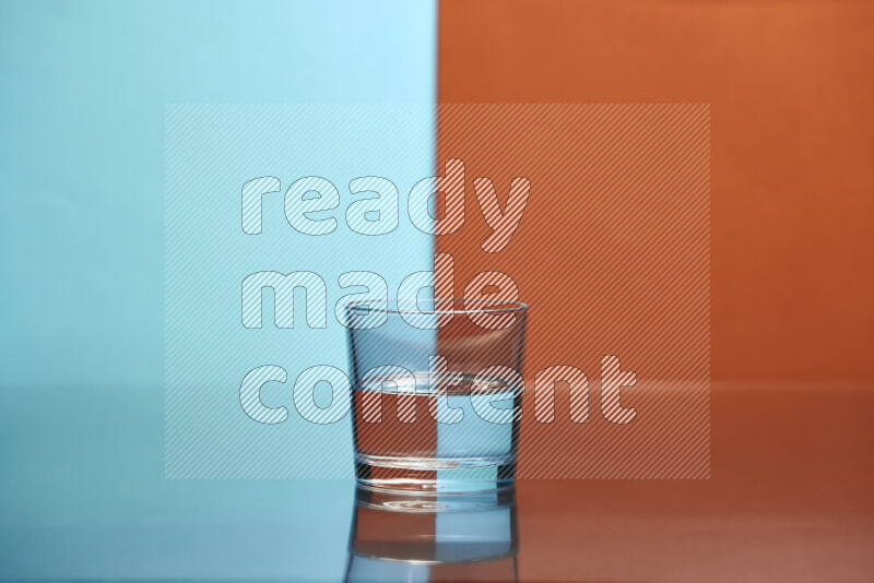 The image features a clear glassware filled with water, set against light blue and dark orange background