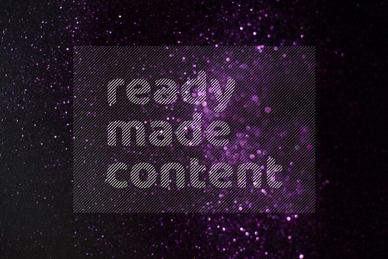 Purple glitter powder isolated on black background