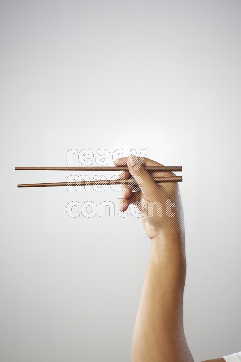 Male Hand Holding Chop Stick on white background