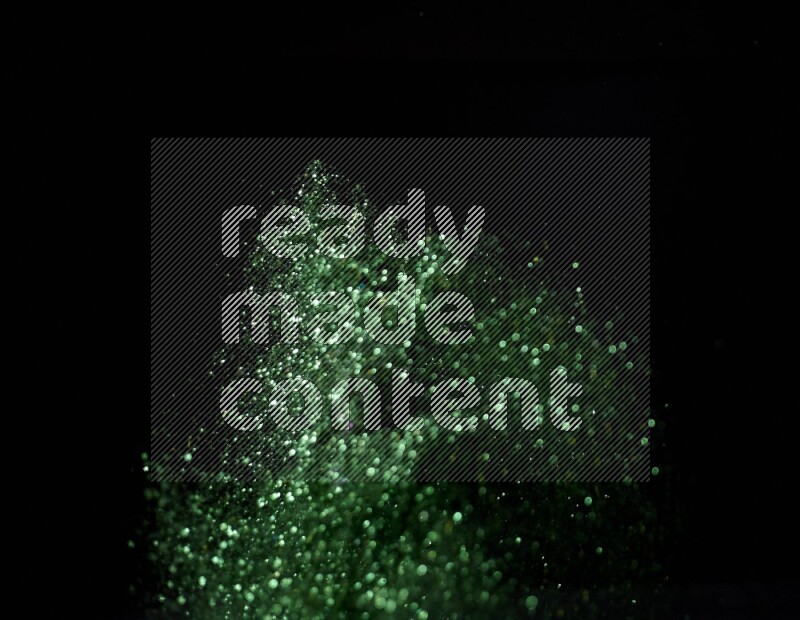 Green glitter powder isolated on black background
