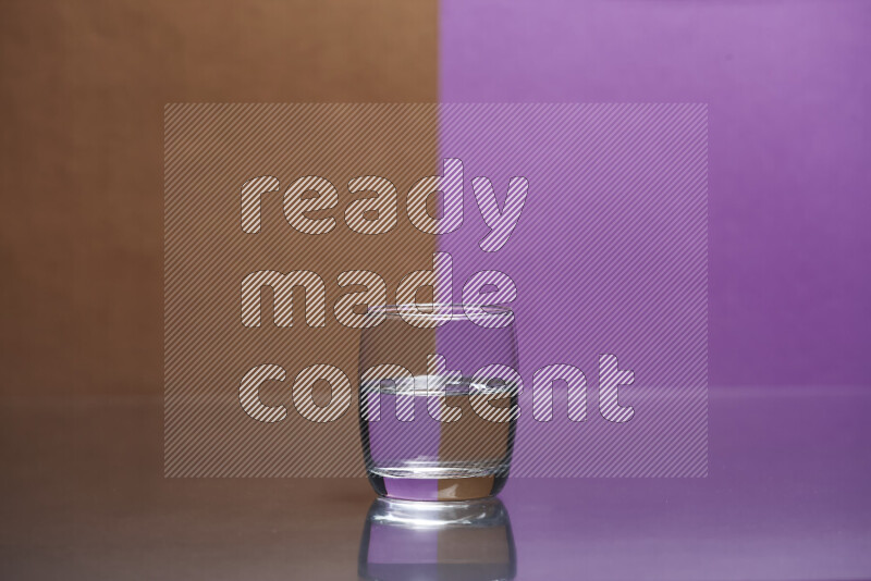 The image features a clear glassware filled with water, set against brown and purple background