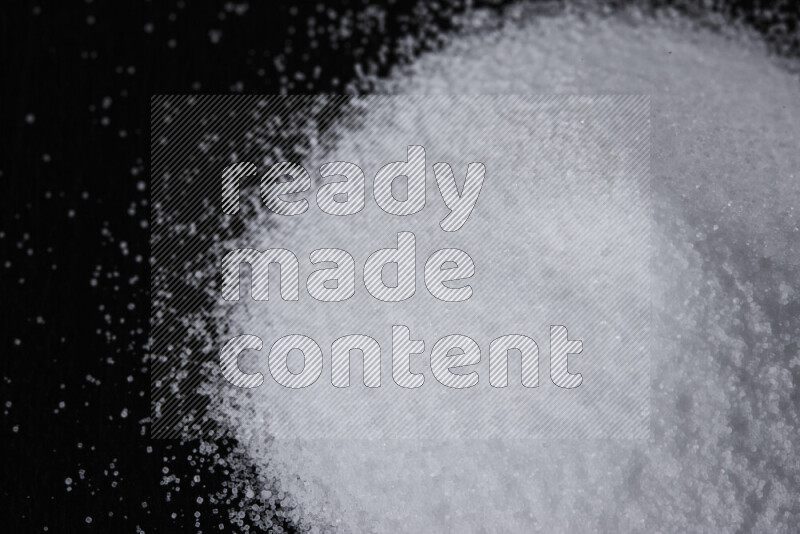 A bunch of fine table salt on black background
