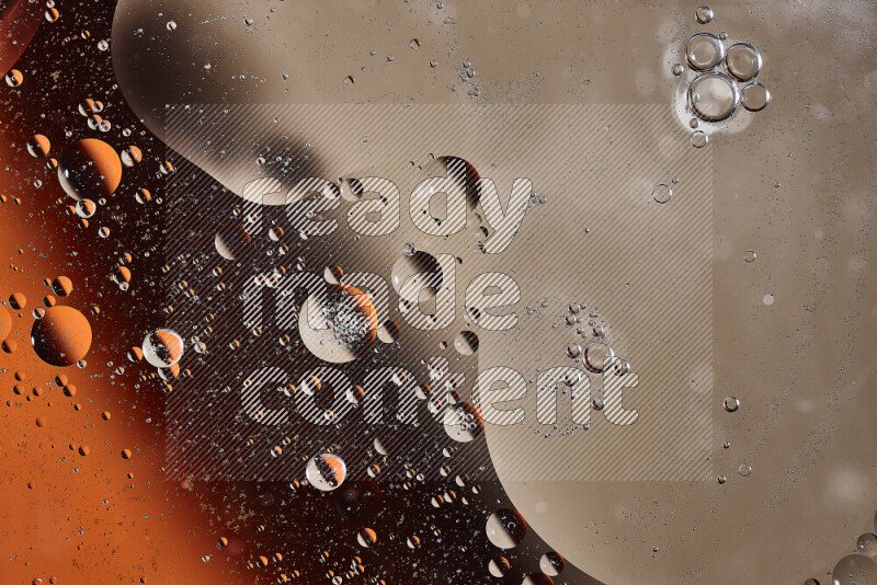 Close-ups of abstract oil bubbles on water surface in shades of orange and brown