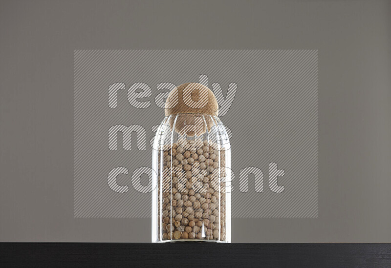 Chickpeas in a glass jar on black background