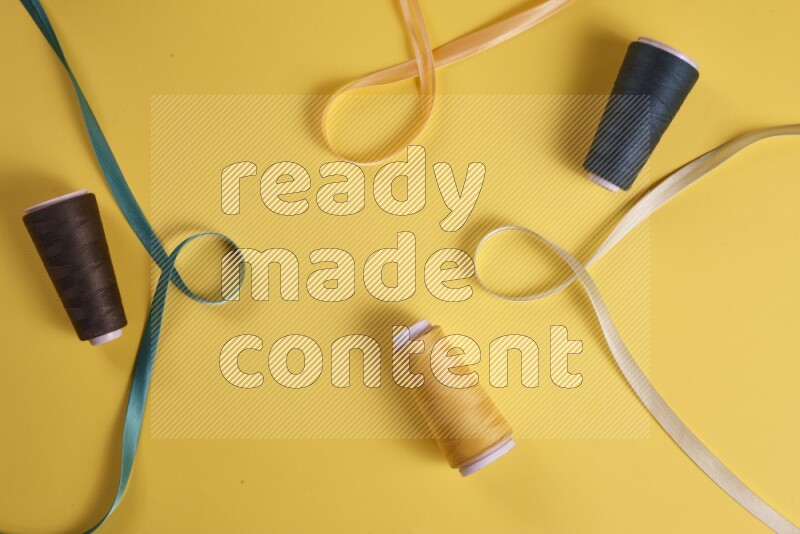 A green collection of sewing and tailoring tools arranged on a yellow background
