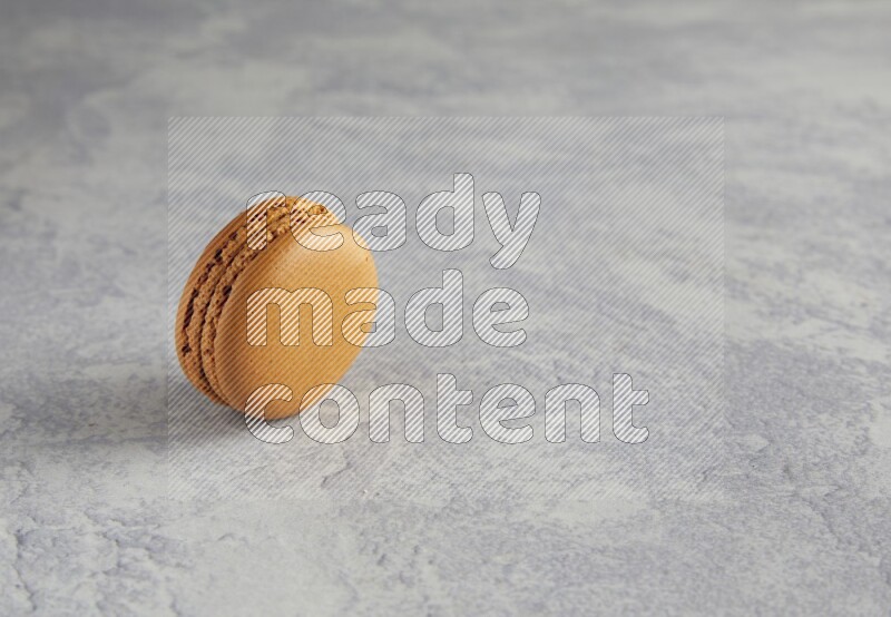 45º Shot of Brown Maple Taffy macaron on white  marble background