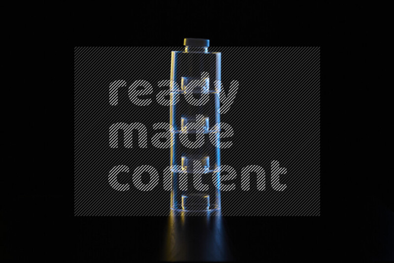 Glassware with rim light in blue and yellow against black background