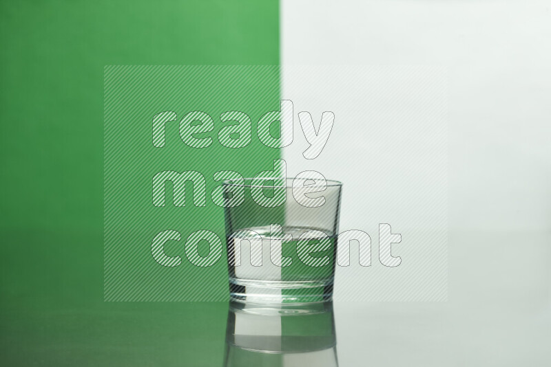 The image features a clear glassware filled with water, set against white and green background