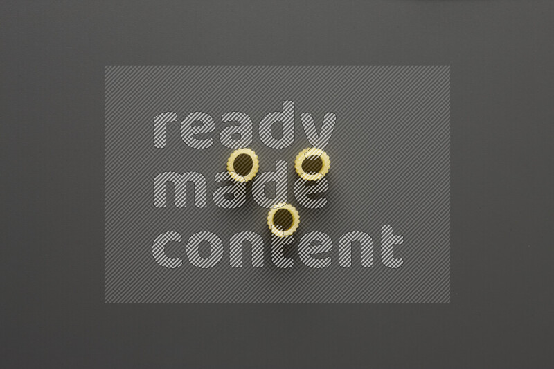 Big rings pasta on grey background