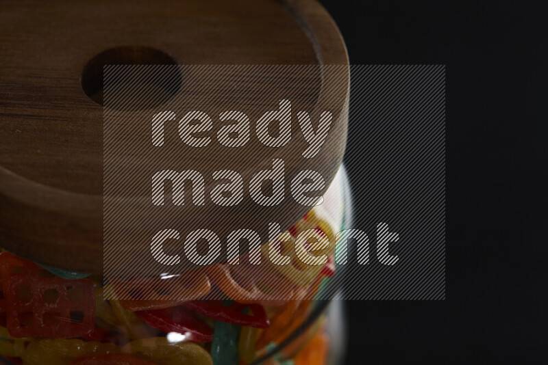 Snacks in a glass jar on black background
