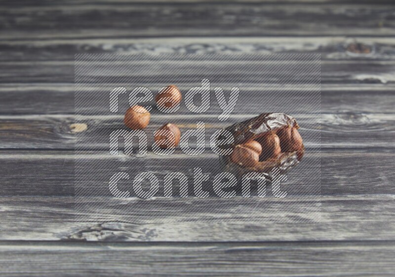 hazelnut stuffed madjoul date on a wooden grey background