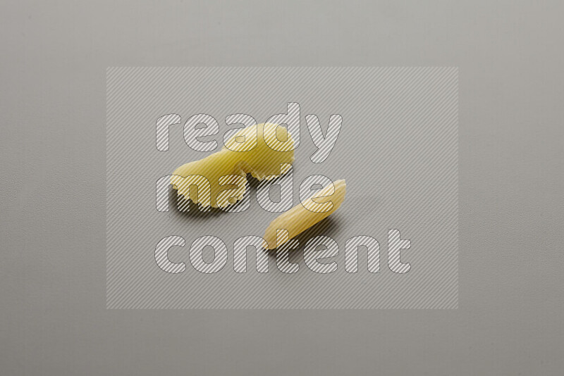 Fiocchi pasta with other types of pasta on grey background