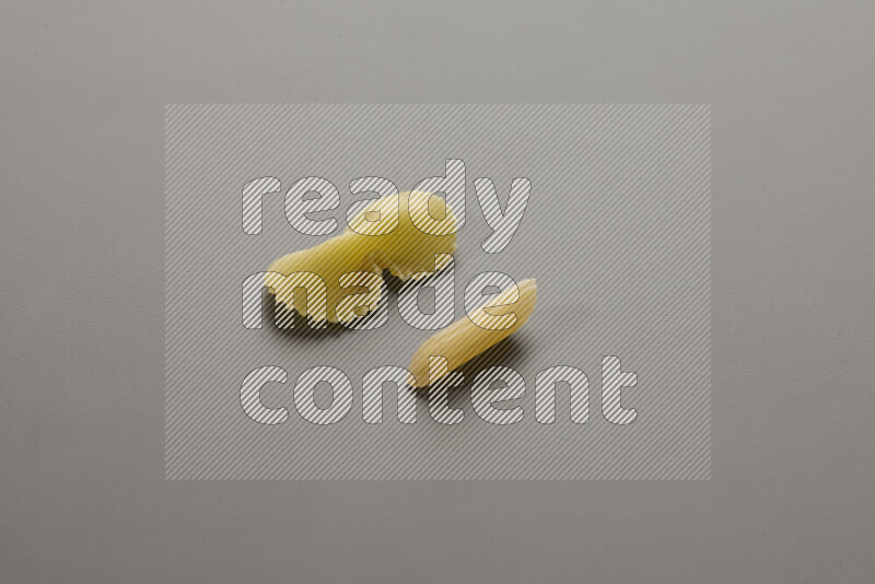 Fiocchi pasta with other types of pasta on grey background