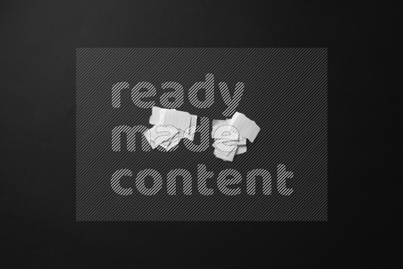 Ripped notebook sheet on black background