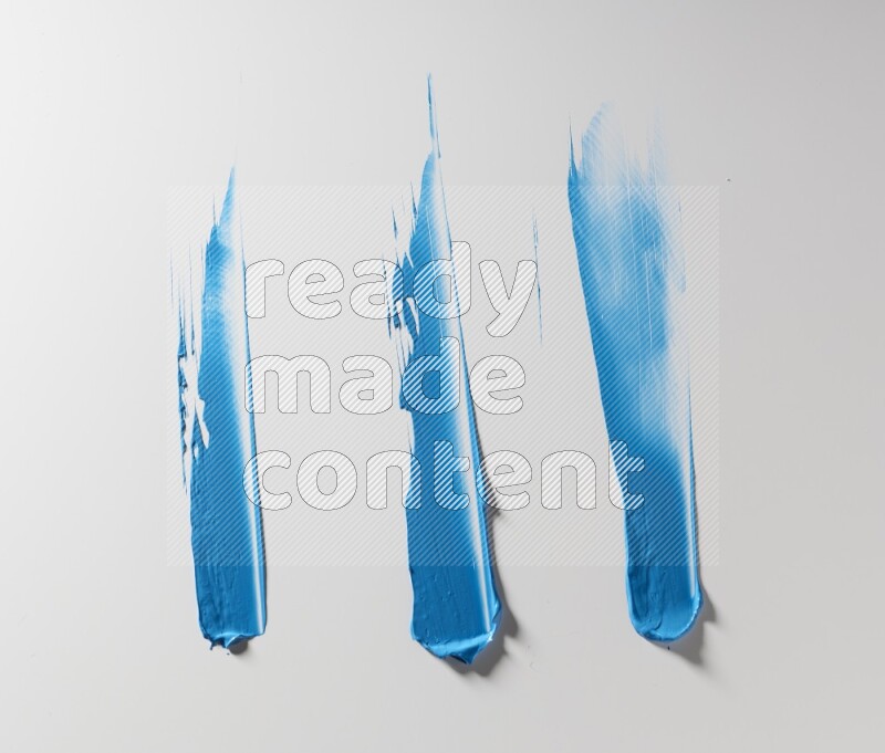 Blue painting knife strokes on white background