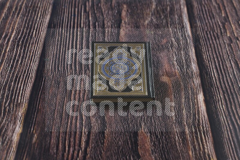 Quran with a prayer beads on wooden background