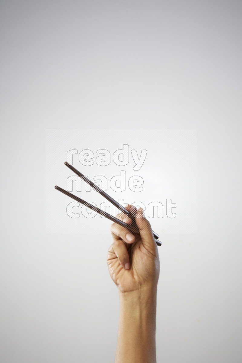 Male Hand Holding Chop Stick on white background