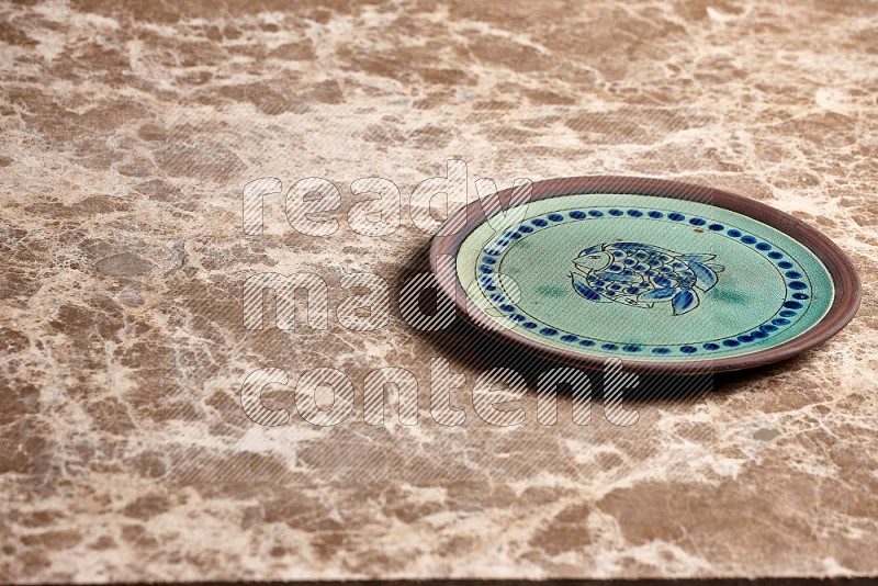 Decorative Pottery Plate on Beige Marble Flooring