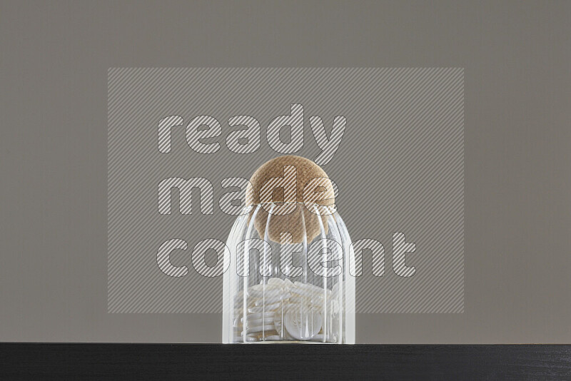 Buttons in a glass jar on black background