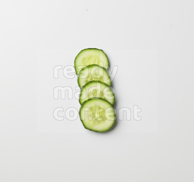 Multiple cucumber slices on white background