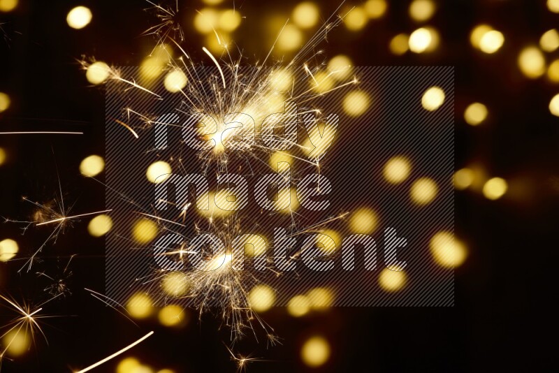 Sparkler candle with yellow light bokeh background