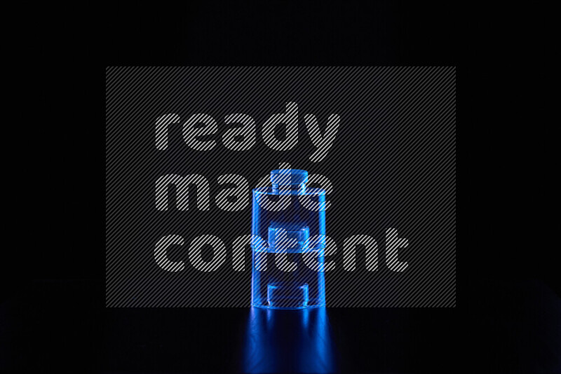 Glassware with rim light in blue against black background