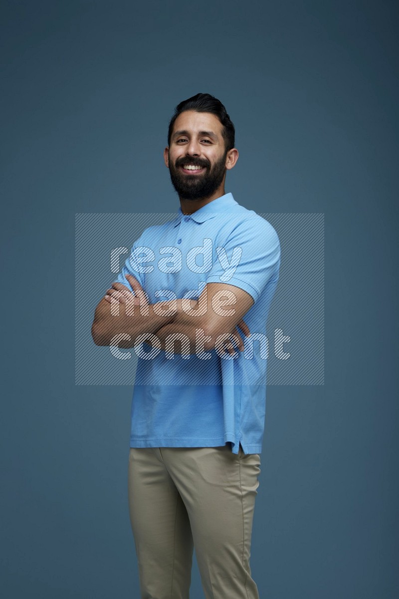 Man posing in a blue background wearing a Blue shirt