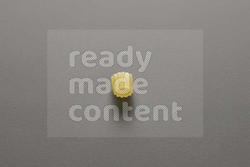 Small rings pasta on grey background