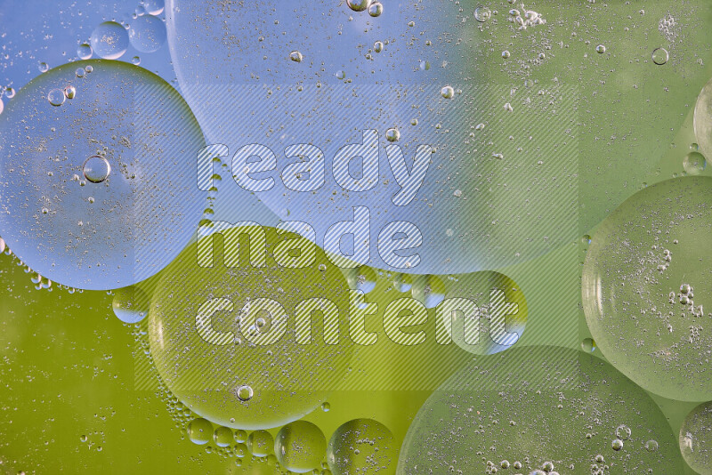 Close-ups of abstract oil bubbles on water surface in shades of green and blue