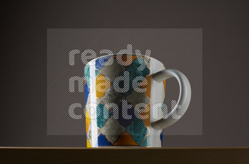 Low angle shot of a decorated cup on grey background