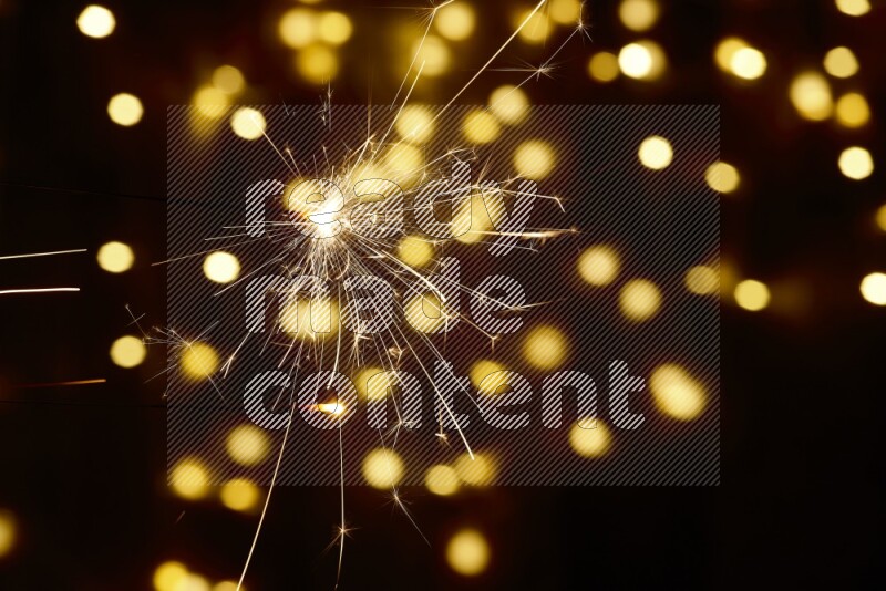 Sparkler candle with yellow light bokeh background