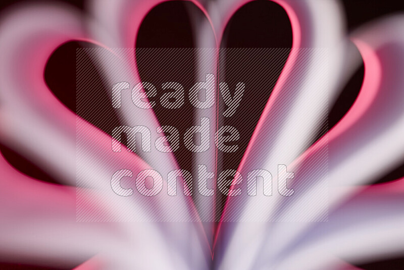 An abstract art piece displaying smooth curves in pink gradients created by colored light